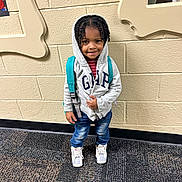 Jeffrey joined the competition — help win amazing prizes! backpack, carpet, casual_clothing, child, expression, fashion, footwear, hair, hoodie, indoor, jeans, mirror, person, portrait, school, smile, sneakers, standing, wall, young_child