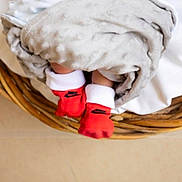 Messiah joined the competition — help win amazing prizes! baby, blanket, basket, feet, red_socks, cozy, infant, soft_texture, woven, sleeping, cute, home, comfortable, wrapped, newborn, footwear, resting, warm, toddler, indoors