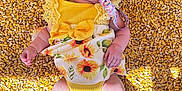 Isabella joined the competition — help win amazing prizes! baby, infant, pacifier, yellow_clothing, sunflower_pattern, corn_kernels, lying_down, sleeping, headband, barefoot, sunlight, shadow, cute, child, outdoor, summer, soft_skin, adorable, resting, bright_colors
