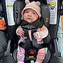 baby, car_seat, infant, pink_hat, knitted_clothing, pacifier, socks, straps, seatbelt, child, cute, indoors, warning_labels, safety, newborn, clothing, person, car_travel, baby_accessory, soft_toys