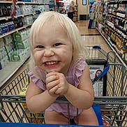 Abigail joined the competition — help win amazing prizes! toddler, shopping_cart, grocery_store, child, smiling, blonde_hair, aisle, water_bottles, wine_bottles, clothing, happy, person, retail, shelf, store, infant, cute, playful, portrait, indoor