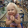 toddler, shopping_cart, grocery_store, child, smiling, blonde_hair, aisle, water_bottles, wine_bottles, clothing, happy, person, retail, shelf, store, infant, cute, playful, portrait, indoor