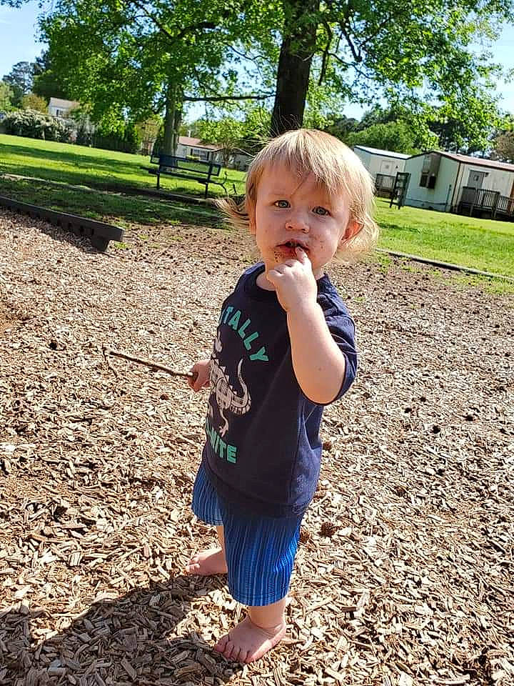 Titus is registered to the contest to win money with this photo: child, fun, grass, leaf, person, plant, play, public_space, recreation, sand, soil, summer, toddler, tree, vacation