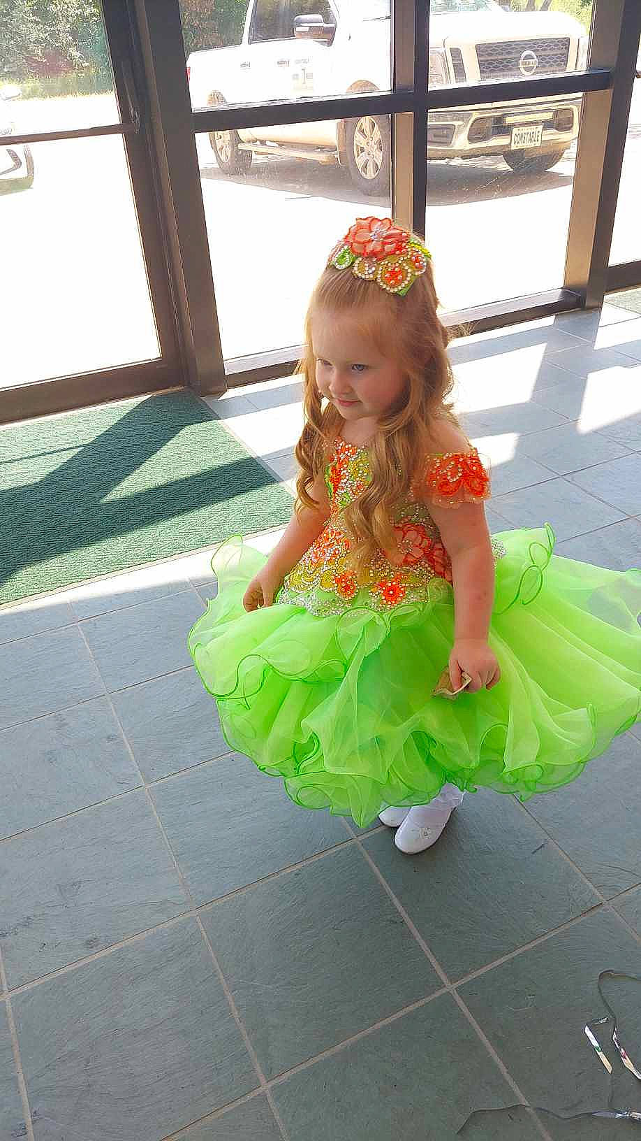 Isabella joined the competition — help win amazing prizes! baby, baby_toddler_clothing, child, costume, dress, embellishment, event, fashion_accessory, flooring, fun, grass, happy, joy, magenta, pattern, person, pink, ruffle, sandal, skin