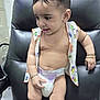 Varun joined the competition — help win amazing prizes! baby, child, diaper, jewelry, bracelet, necklace, shirt, black_chair, indoor, curly_hair, cute, skin, sitting, expression, furniture, young, infant, person, plump, accessory