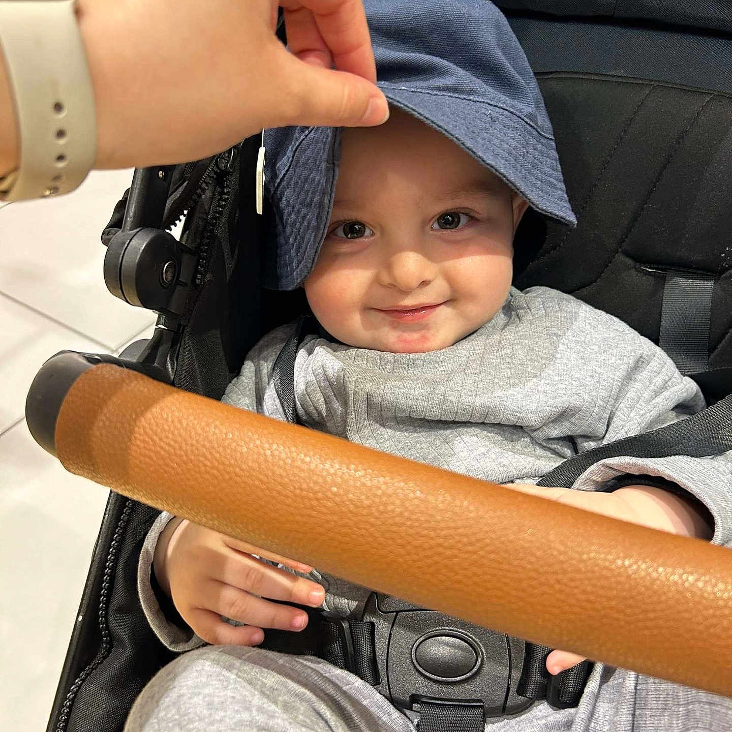 Musa is registered to the contest to win money with this photo: accessories, baby, babylaughing, baseballcap, bodypart, cap, clothing, face, finger, hand, happy, hat, head, pants, people, person, photography, portrait, smile, sunhat