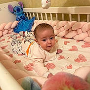 Télyana a rejoint le concours — aidez-le/la à gagner de superbes lots ! baby, crib, plush_toy, braided_bumper, heart_pattern, tummy_time, soft_toys, infant, sleeping_area, baby_clothing, cute, indoor, child, smiling_mobile, pink, white_crib, cozy, playful, decor, nursery