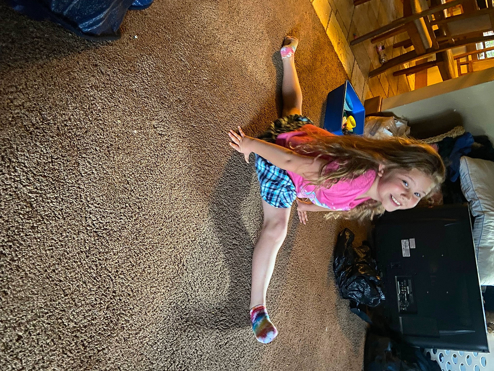 Jordyn is registered to the contest to win money with this photo: child, city, floor, flooring, fun, human_leg, joy, knee, leisure, magenta, person, play, recreation, road_surface, room, sandal, sitting, thigh, toddler, vacation