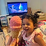 Camilla joined the competition — help win amazing prizes! toddler, ice_cream, cone, pink, sprinkles, smile, curly_hair, living_room, television, animation, sofa, blanket, socks, child, happy, playful, person, indoors, casual_clothing, hand