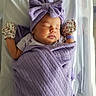 newborn, baby, sleeping, purple_blanket, headwrap, mittens, hospital_bassinet, infant, peaceful, swaddled, face, person, sleep, soft_light, closeup, cozy, cute, child, wrapped, resting