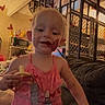 Lillian joined the competition — help win amazing prizes! toddler, child, indoor, pink_dress, pacifier, smiling, heart_doodles, stairs, couch, baby, person, furniture, home, happy, cute, holding, blonde, young_child, playful, casual