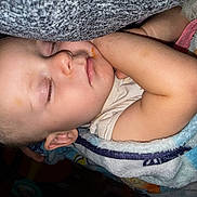 Lillian is registered to the contest to win money with this photo: child, toddler, sleeping, blanket, face, arm, cozy, nap, indoors, peaceful, cute, infant, resting, skin, clothing, head, closed_eyes, comfort, young, baby