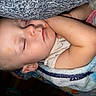 child, toddler, sleeping, blanket, face, arm, cozy, nap, indoors, peaceful, cute, infant, resting, skin, clothing, head, closed_eyes, comfort, young, baby