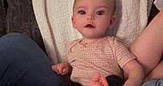 Paislyn joined the competition — help win amazing prizes! baby, infant, child, blanket, couch, legs, jeans, sitting, indoors, cozy, person, cute, face, expression, soft_lighting, digital_drawing, devil_horns, relaxing, home, casual