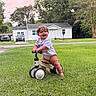 baby, child, daylight, fun, grass, greenery, happy, house, lawn, nature, outdoor, person, play, smiling, summer, toddler, toy, tree, tricycle, vehicle