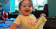 Remi joined the competition — help win amazing prizes! toddler, child, smiling, indoor, playroom, colorful, clothing, table, toy, furniture, happy, person, bow, hair, window, carpet, light, room, playing, cute