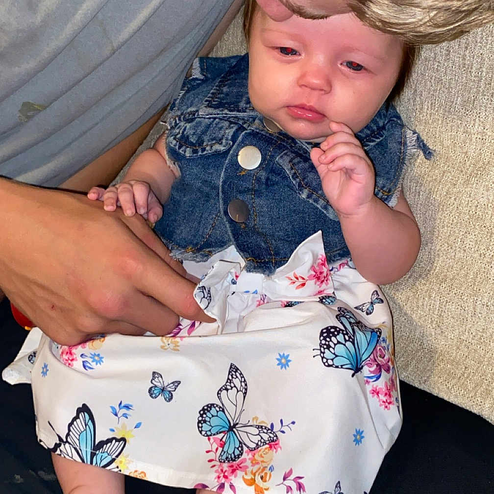 Nova is registered to the contest to win money with this photo: baby, blouse, bodypart, clothing, couch, dress, face, finger, furniture, hand, head, jeans, kissing, newborn, pants, person, photography, portrait, romantic, shorts