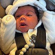 Legend joined the competition — help win amazing prizes! baby, infant, car_seat, white_hoodie, pacifier, straps, cute, child, newborn, face, expression, clothing, indoors, soft_texture, bundle, portrait, seatbelt, accessory, black_strap, closeup