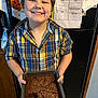 Davis is registered to the contest to win money with this photo: baking, boy, brownies, child, cooking, food, happy, home, indoor, kitchen, pan, paper, person, photo, plaid_shirt, portrait, refrigerator, smile, snack, standing