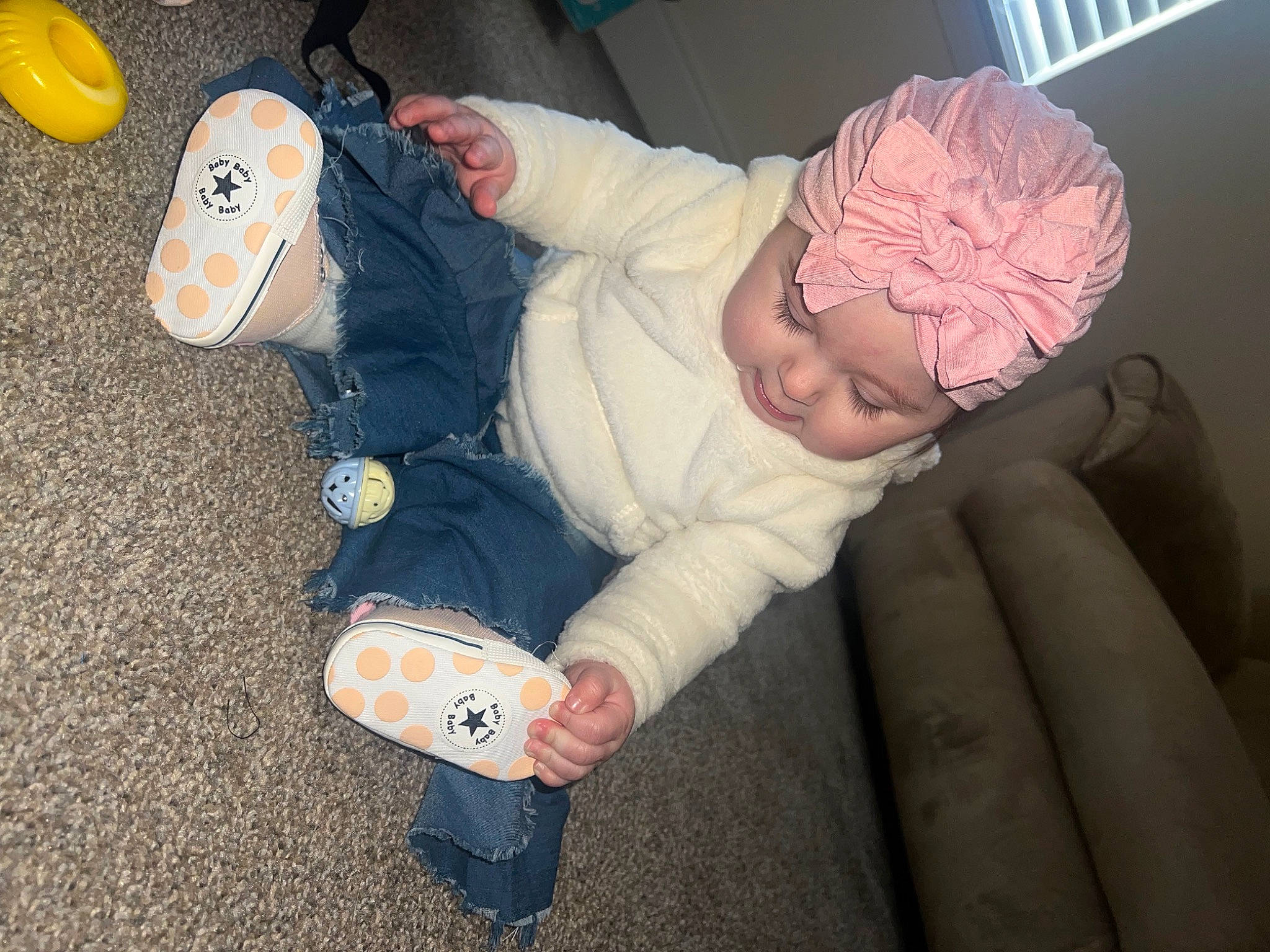 Oaklyn is registered to the contest to win money with this photo: baby, baby_products, baby_toddler_clothing, cheek, child, comfort, finger, flooring, foot, fun, hand, headwear, human_leg, leg, nail, person, room, sitting, sock, thumb