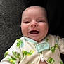 Zachary is registered to the contest to win money with this photo: baby, infant, smiling, onesie, frog_pattern, clothing, face, cute, joyful, happy, child, portrait, closeup, indoors, human, skin, expression, newborn, baby_clothes, person