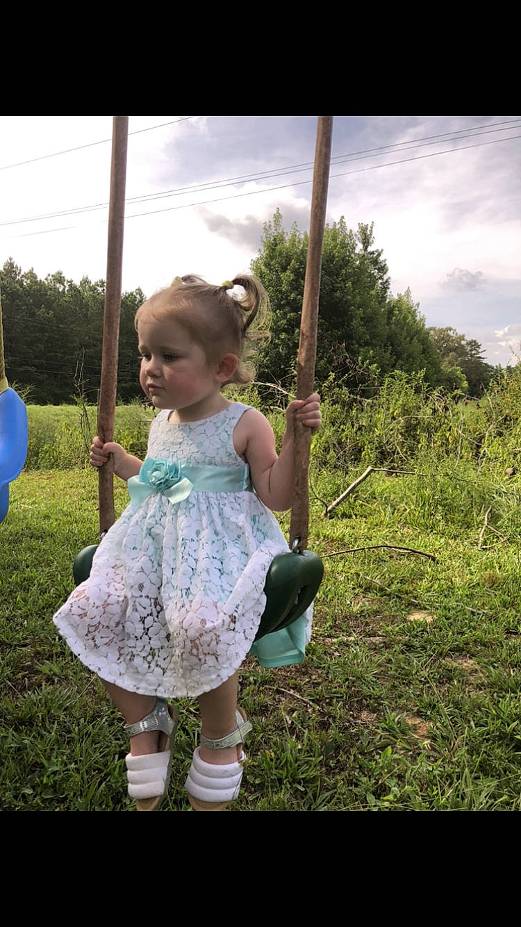 Katelyn is registered to the contest to win money with this photo: baby_toddler_clothing, balloon, child, cloud, dress, flash_photography, fun, grass, grassland, hair, happy, leisure, meadow, people_in_nature, person, play, recreation, sitting, sky, toddler