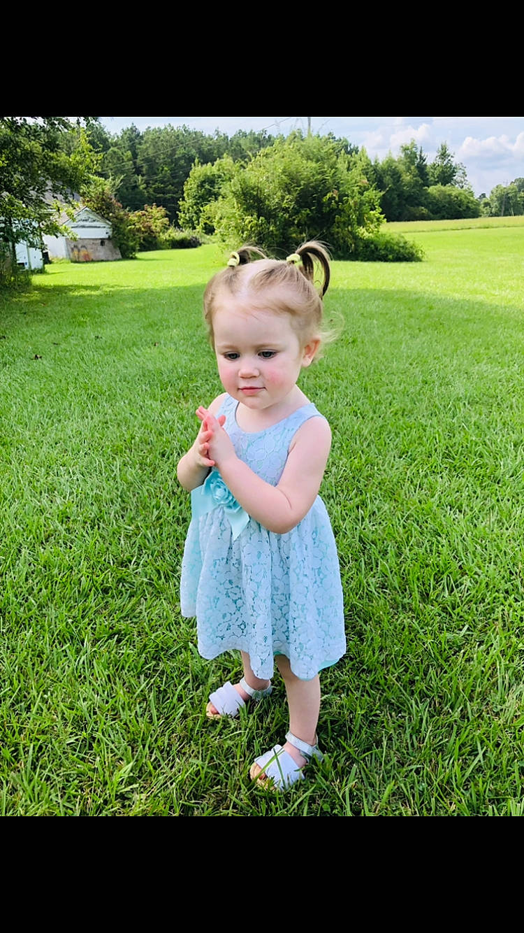 Katelyn joined the competition — help win amazing prizes! baby_toddler_clothing, botany, child, eye, fun, grass, grass_family, grassland, green, happy, leaf, meadow, natural_environment, people_in_nature, person, pink, plant, standing, sunlight, toddler