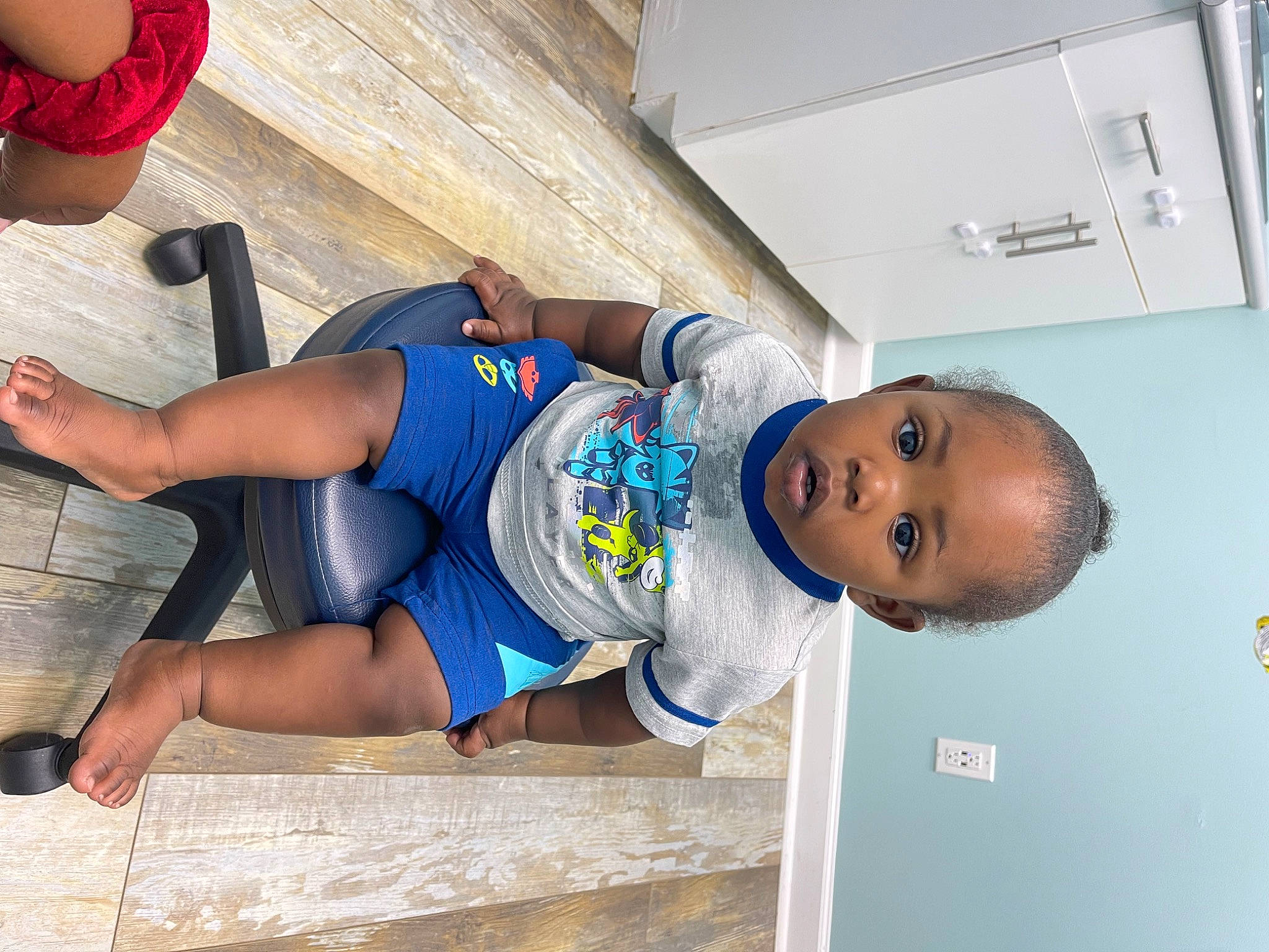 Jonah is registered to the contest to win money with this photo: abdomen, chest, child, elbow, electric_blue, foot, fun, hat, human_leg, joint, knee, leisure, person, shorts, sleeve, sportswear, t_shirt, thigh, toddler, trunk