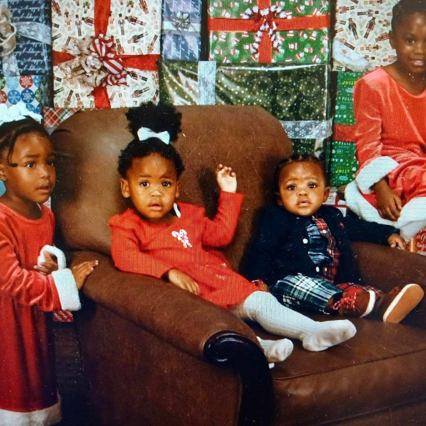 Royalty joined the competition — help win amazing prizes! child, children, christmas, holiday, presents, gift_wrap, red_dress, plaid_pants, brown_chair, indoor, portrait, smile, sitting, standing, white_tights, hair_bow, holiday_attire, family, festive, cute