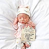 Ace'Lynn is registered to the contest to win money with this photo: newborn, baby, infant, sleeping, hat, pajamas, sign, birth_announcement, blanket, soft, cute, lying_down, indoors, peaceful, small_hands, small_feet, pink, white, child, portrait