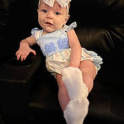 Hadleigh is registered to the contest to win money with this photo: baby, blue_eyes, bow, child, clothing, cute, elephant_applique, face, foot, hand, headband, indoor, infant, leather_chair, portrait, romper, sitting, skin, smiling, sock