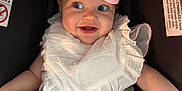 Hadleigh is registered to the contest to win money with this photo: arm, baby, bib, bracelet, car_seat, child, cute, eyes, face, happy, indoor, infant, legs, mouth, pink_bow, sitting, skin, smile, straps, white_clothing