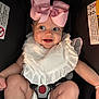arm, baby, bib, bracelet, car_seat, child, cute, eyes, face, happy, indoor, infant, legs, mouth, pink_bow, sitting, skin, smile, straps, white_clothing