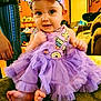 baby, child, tutu, purple, dress, bow, headband, sitting, feet, living_room, couch, furniture, person, cute, smile, indoors, decor, hand, expression, foot