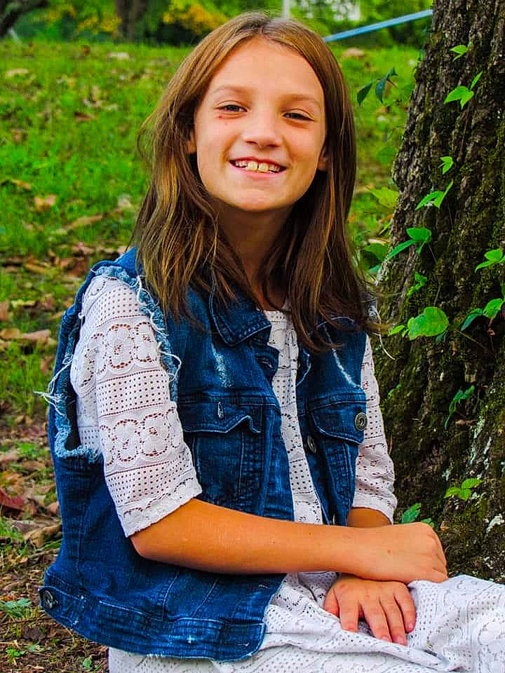 Madyson joined the competition — help win amazing prizes! brown_hair, button, child_model, denim, electric_blue, feathered_hair, joy, laugh, layered_hair, long_hair, old_growth_forest, overall, pattern, people_in_nature, person, portrait, portrait_photography, sleeve, tooth, trunk