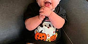 Melody joined the competition — help win amazing prizes! baby, child, smiling, happy, sitting, couch, clothing, headband, halloween, pumpkin, ghost, bat, spider, face, person, indoor, cute, pants, black_shirt, yellow