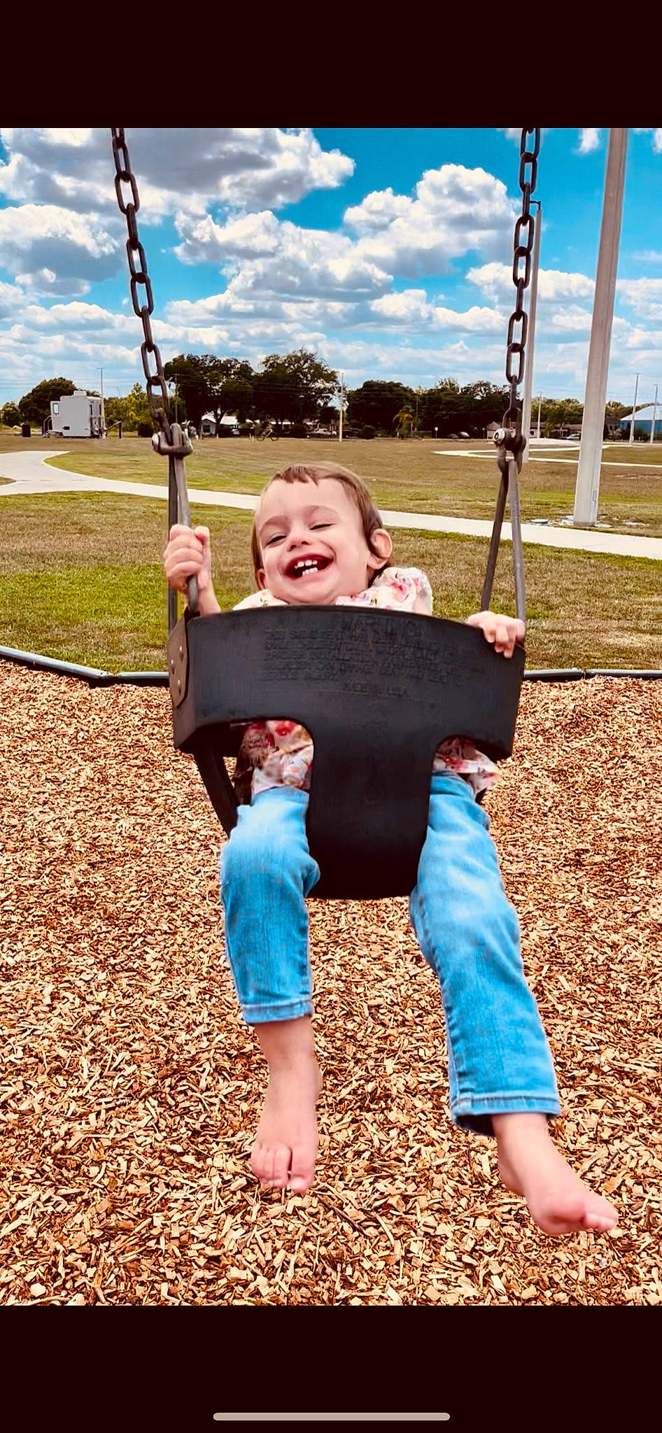Rosalie joined the competition — help win amazing prizes! baby_toddler_clothing, blue, city, cloud, fun, grass, green, happy, joy, leisure, people, people_in_nature, person, playground, public_space, recreation, sky, smile, summer, swing