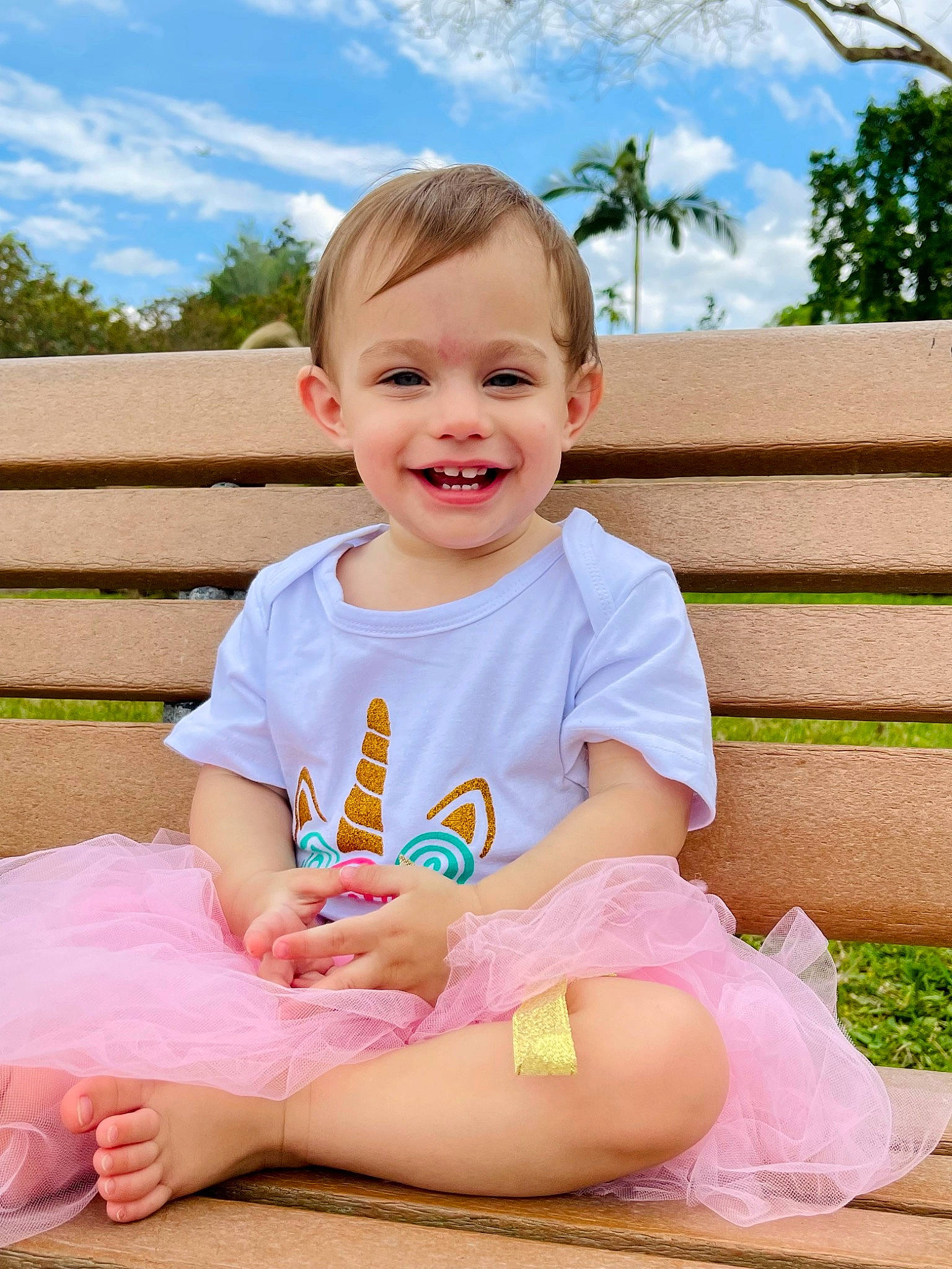 Rosalie is registered to the contest to win money with this photo: baby_toddler_clothing, child, cloud, face, facial_expression, fun, grass, happy, iris, joy, leisure, person, pink, plant, skin, sky, smile, summer, t_shirt, thigh