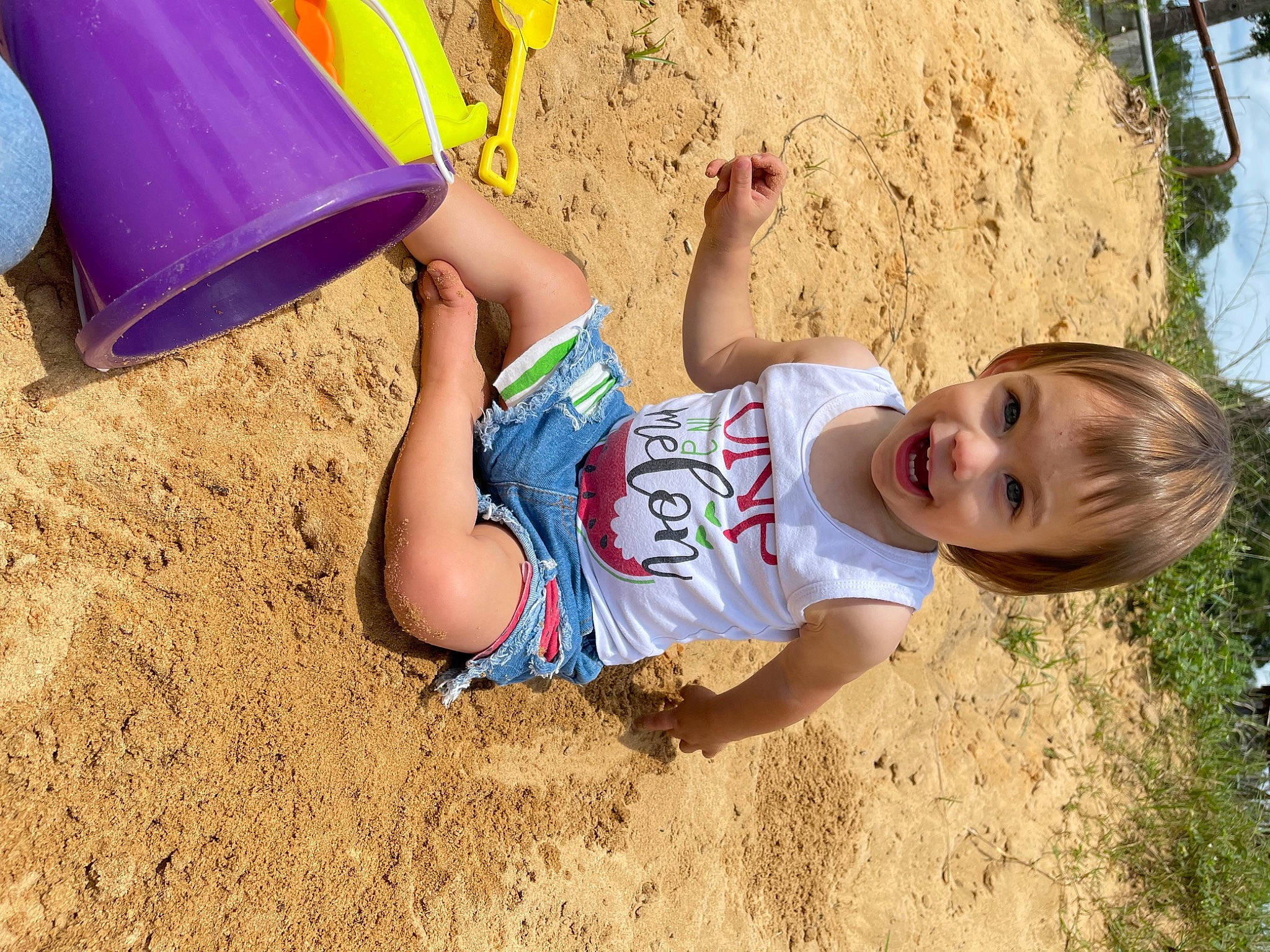 Rosalie is registered to the contest to win money with this photo: child, foot, fun, grass, happy, human_leg, landscape, leg, leisure, people_in_nature, people_on_beach, person, recreation, sand, shorts, soil, t_shirt, thigh, toddler, tree
