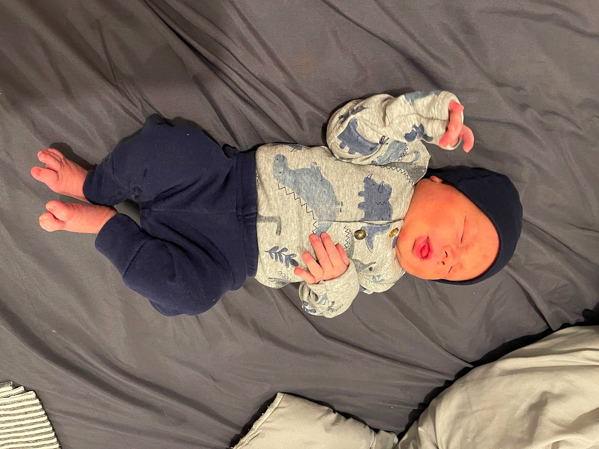 Wyatt is registered to the contest to win money with this photo: baby, baby_products, baby_toddler_clothing, bedtime, child, comfort, elbow, finger, fun, hat, headwear, human_body, linens, nap, person, room, sitting, sleep, sleeve, smile