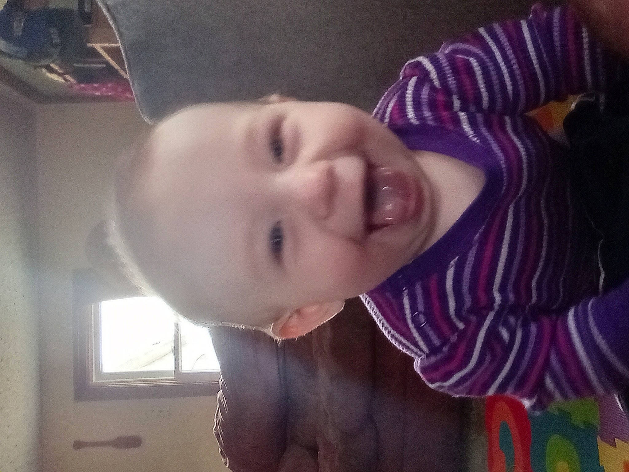 Ocean is registered to the contest to win money with this photo: cheek, chin, ear, eyebrow, eyelash, forehead, happy, human_body, iris, jaw, lip, mouth, neck, nose, person, purple, skin, smile, toddler, tooth