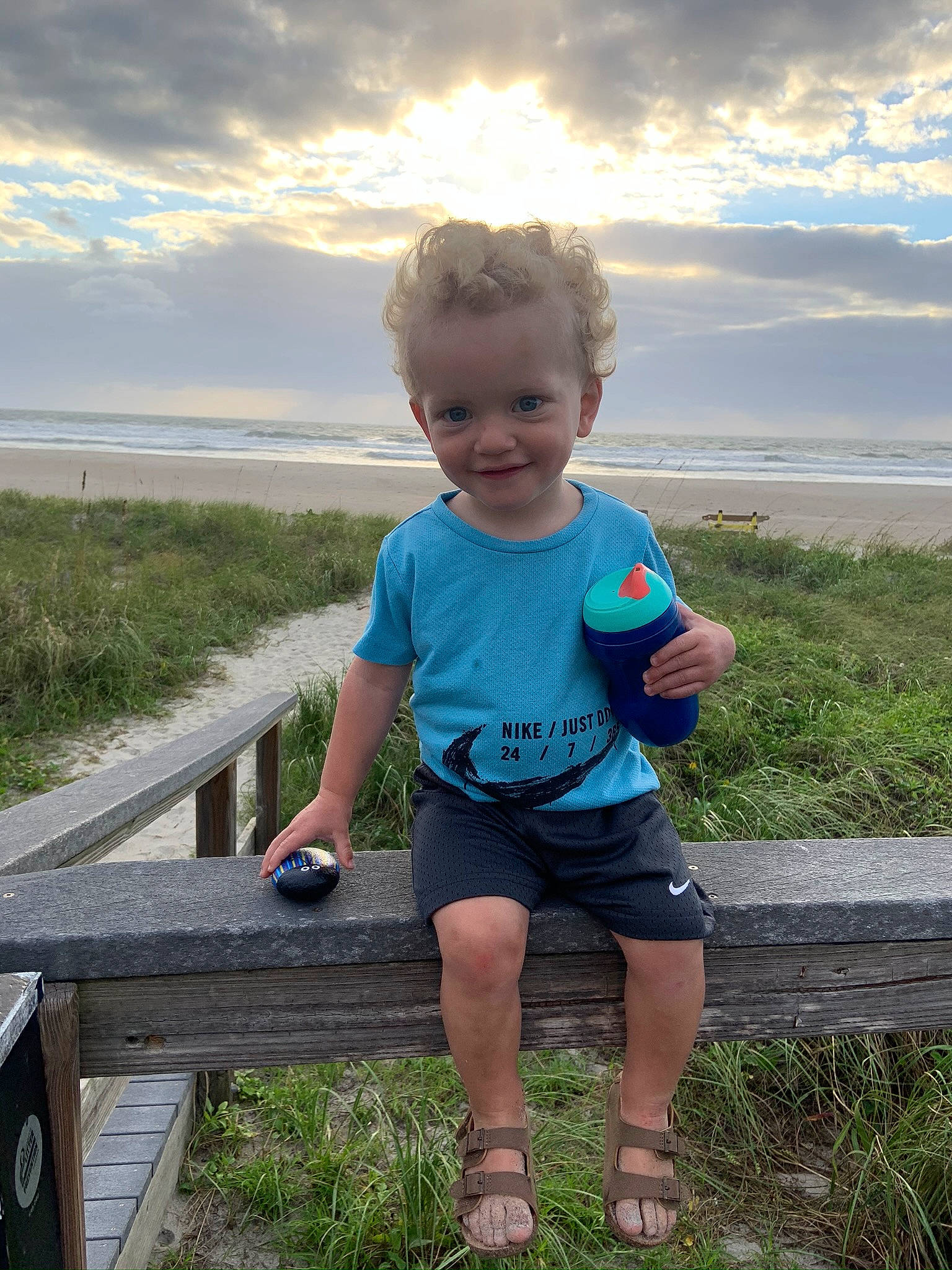 Carter joined the competition — help win amazing prizes! azure, baby_toddler_clothing, cloud, electric_blue, fun, grass, grassland, happy, joy, landscape, leisure, natural_environment, people_in_nature, person, plant, recreation, shorts, sitting, sky, summer