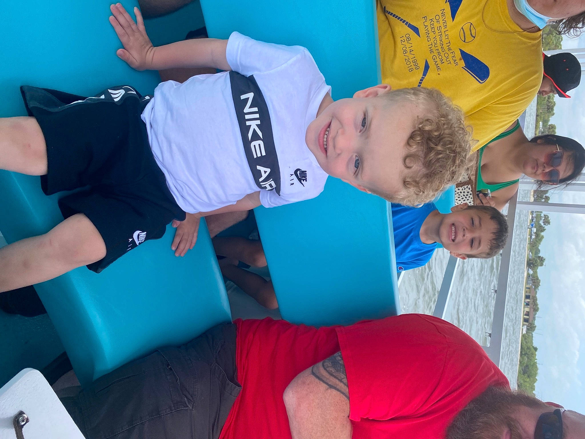 Carter is registered to the contest to win money with this photo: aqua, azure, blue, child, comfort, elbow, electric_blue, fun, happy, hat, joint, joy, knee, leisure, person, recreation, red, shorts, t_shirt, toddler