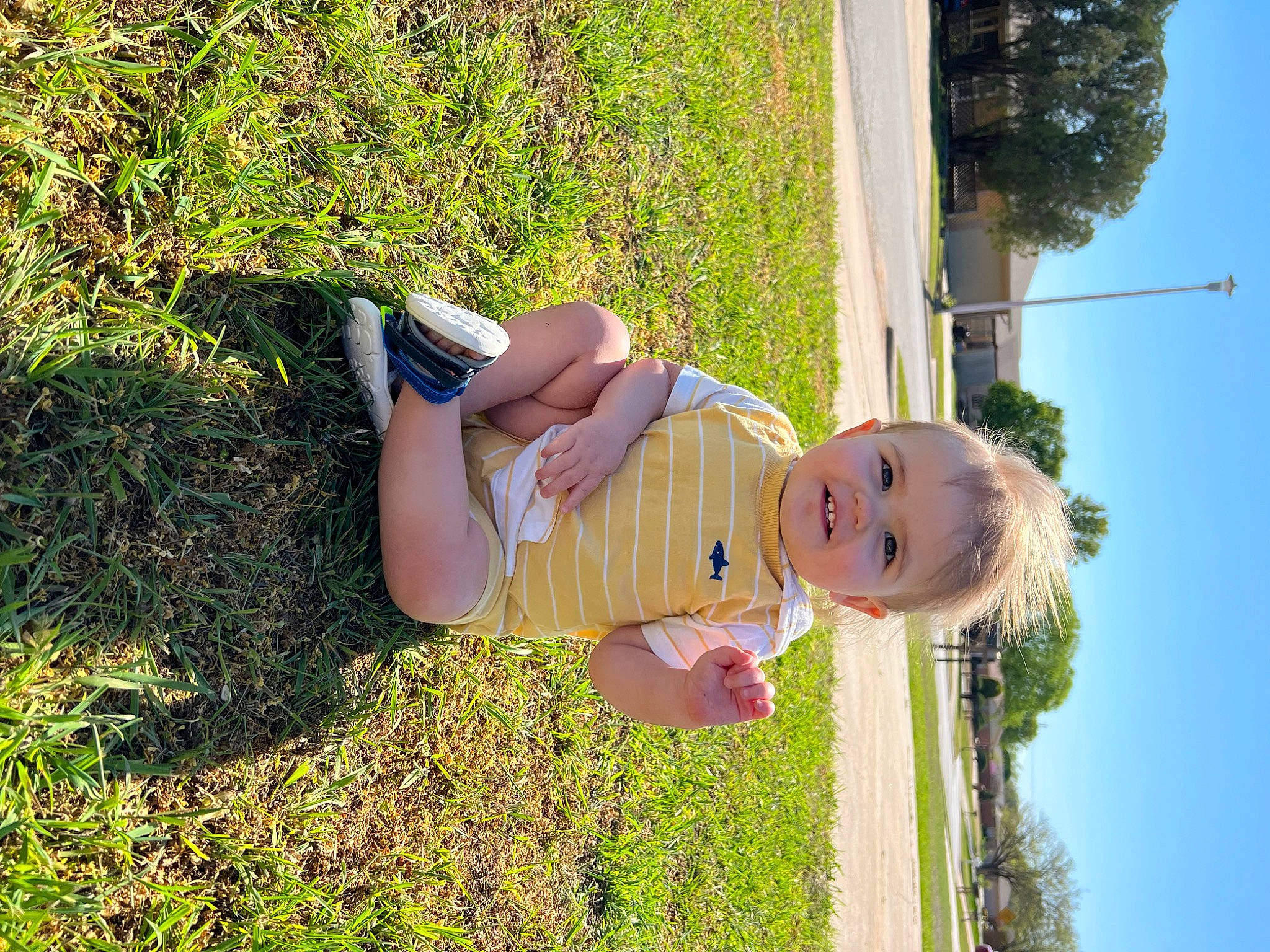 Landon is registered to the contest to win money with this photo: baby, baby_toddler_clothing, child, fun, grass, grassland, happy, house, lawn, leisure, people_in_nature, person, plant, recreation, sky, smile, sunlight, t_shirt, toddler, tree
