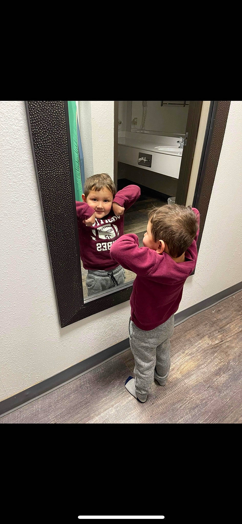 Cason is registered to the contest to win money with this photo: baby, baby_toddler_clothing, child, door, flooring, fun, gesture, happy, magenta, person, room, shoe, sitting, sleeve, smile, sneakers, t_shirt, toddler, tree, visual_arts