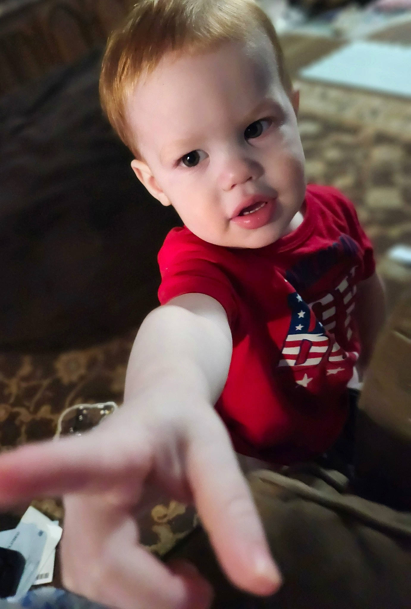 Everett is registered to the contest to win money with this photo: baby_toddler_clothing, blond, cheek, elbow, eye, face, finger, flash_photography, grass, happy, head, human_leg, iris, lip, person, skin, sleeve, smile, t_shirt, toddler