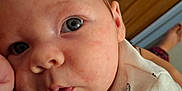 Brody joined the competition — help win amazing prizes! baby, child, chubby_cheeks, close_up, curious, cute, expression, face, foot, furniture, indoor, infant, onesie, person, portrait, resting, skin, soft_lighting, tiger_print, young
