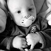 Soan participe au concours pour gagner de l'argent avec cette photo : baby, infant, pacifier, blanket, hands, closeup, face, monochrome, black_and_white, soft, cute, child, sleeping_bag, clothing, portrait, newborn, cozy, expression, young, resting