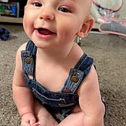 Attlee is registered to the contest to win money with this photo: baby, child, infant, denim_overalls, smile, happy, sitting, carpet, indoor, cute, face, skin, hand, foot, person, expression, young, home, furniture, toy
