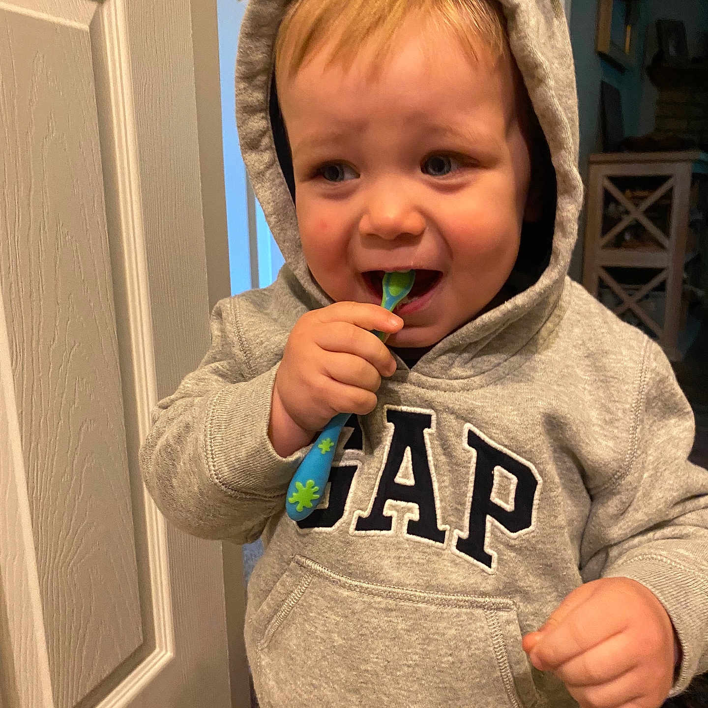 Parker joined the competition — help win amazing prizes! baby, bodypart, brush, clothing, coat, cutlery, device, face, head, jacket, knitwear, mouth, person, photography, portrait, spoon, sweater, teeth, tool, toothbrush